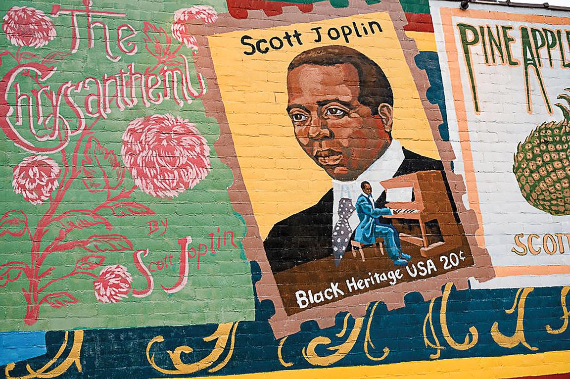 A colorful mural depicting, among other things, a painting of Scott Joplin